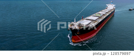Aerial view bulk carrier cargo ship vessel global business logistic import export industry, Bulk carrier cargo ship vessel dry general cargo vessel underway on sea to port. Aerial view bulk carrier cargo ship vessel global business logistic import export industry, Bulk carrier cargo ship vessel dry general cargo vessel underway on sea to port. 128579897