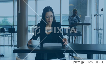 Flat design showing woman with coffee and tablet while coworker working on laptop in office cafe 128580101