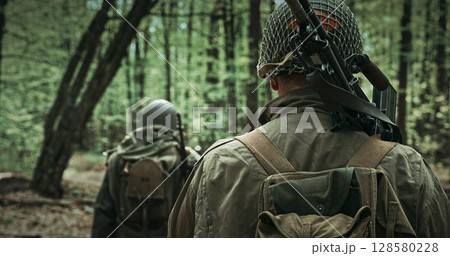 Two Soldiers in the Forest with Vintage Military Gear Two Soldiers in the Forest with Vintage Military Gear 128580228