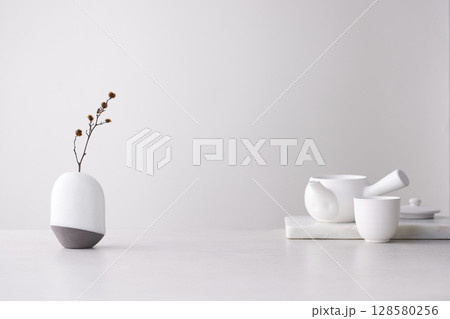 Elegant Korean table setting with traditional Korean bojagi gift wrapping for Chuseok, ceramic vase and fabric, tree branches. Elegant Korean table setting with traditional Korean bojagi gift wrapping for Chuseok, ceramic vase and fabric, tree branches. 128580256