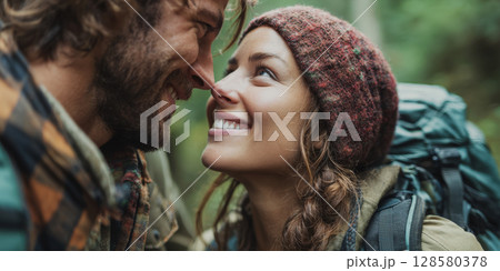 A close-up portrait of a happy couple sharing an intimate moment in a natural setting, their smiles reflecting a strong bond and affection, perfect for themes of love, relationships, and outdoor 128580378
