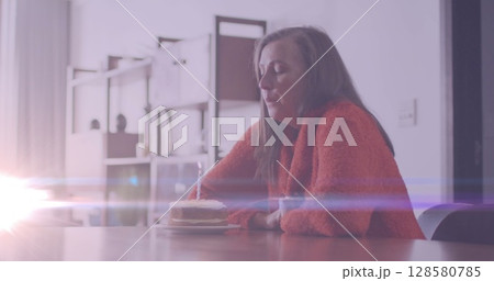 Image of glowing lights over a sad, lonely caucasian woman Image of glowing lights over a sad, lonely caucasian woman 128580785
