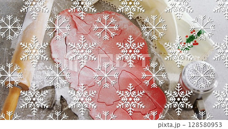 Image of snowflakes over cookies dough and mold 128580953