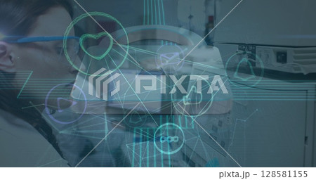 Image of network of connections with icons over diverse doctors 128581155