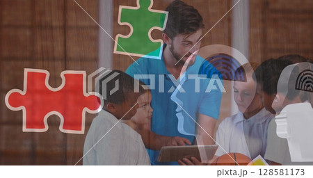 Image of puzzle pieces over diverse schoolchildren using tablet Image of puzzle pieces over diverse schoolchildren using tablet 128581173