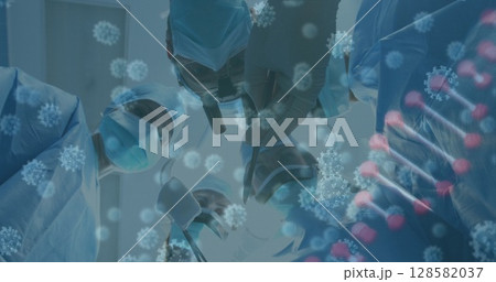 Image of covid 19 cells and dna strand over caucasian surgeons in face masks 128582037