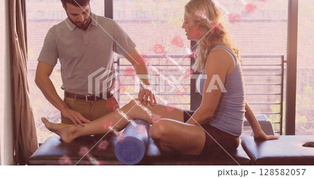Image of dna strand over caucasian male massage therapist with female patient Image of dna strand over caucasian male massage therapist with female patient 128582057