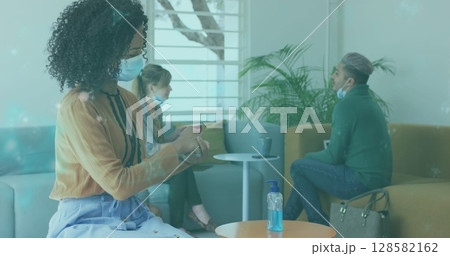 Image of data processing over businesswomen wearing face masks 128582162