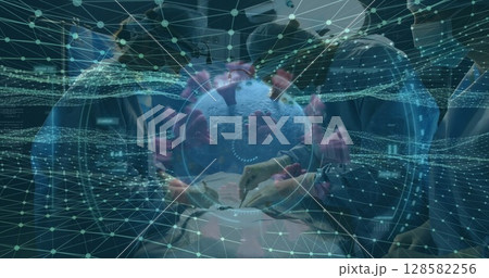 Floating 3D virus model showing pink spike proteins in hospital OR, with data network grid overlay 128582256