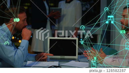 Image of network of connections with icons over diverse businessmen in office 128582287