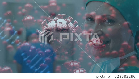 Smiling surgeon in surgical cap, gown in hospital, with virus particles and DNA strands, copy space 128582296