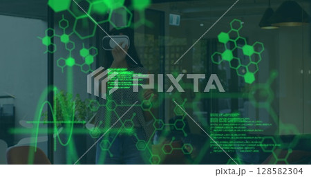 Image of scientific data over caucasian woman wearing vr headset in office 128582304