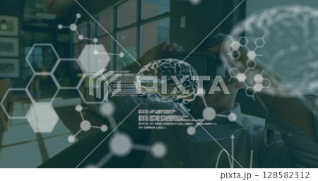 Image of scientific data over caucasian man wearing vr headset in office 128582312