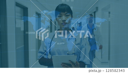 Image of world map and financial data over asian female doctor making notes 128582343