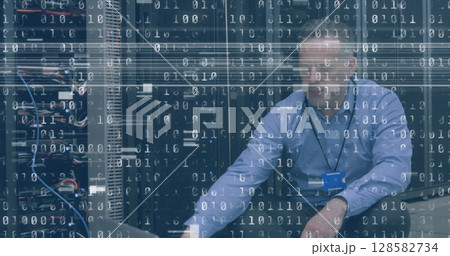 Image of interference and binary coding over caucasian man using laptop in server room Image of interference and binary coding over caucasian man using laptop in server room 128582734