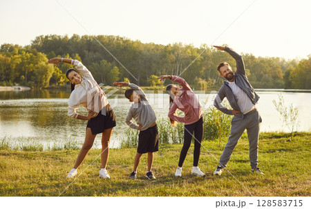 Happy Family Embraces Fitness Together in Nature Happy Family Embraces Fitness Together in Nature 128583715