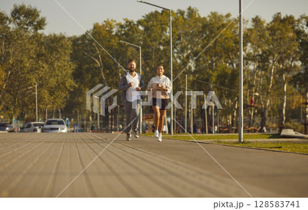Couple jogging in the park having sport workout in nature together. Healthy lifestyle concept. 128583741