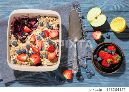 apple blueberry strawberry crumble in baking dish 128584175