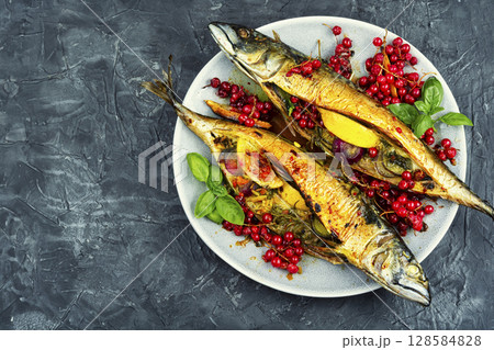 Fried or baked mackerel fish with berries. 128584828
