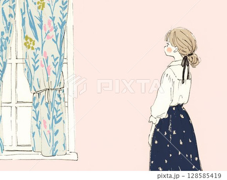 窓辺に立つ女の子と花柄カーテンのある朝 128585419
