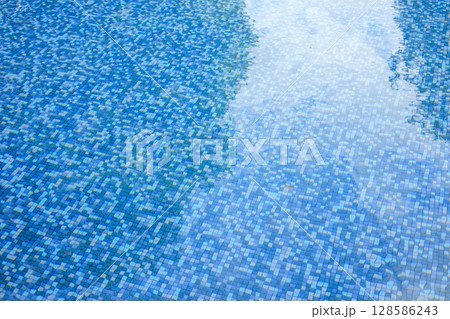 Swimming pool water surface and ripple wave with blue mosaic tiles Swimming pool water surface and ripple wave with blue mosaic tiles 128586243