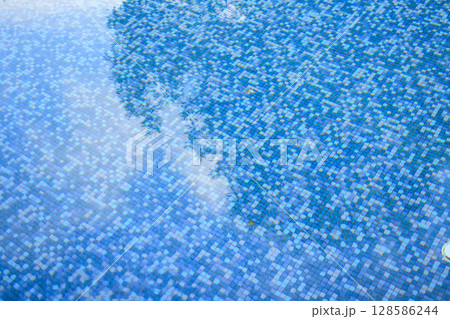 Swimming pool water surface and ripple wave with blue mosaic tiles Swimming pool water surface and ripple wave with blue mosaic tiles 128586244