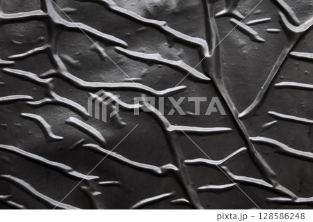 black crumpled and creased plastic poster texture background 128586248