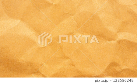 Abstract crumpled and creased recycle brown paper texture background 128586249
