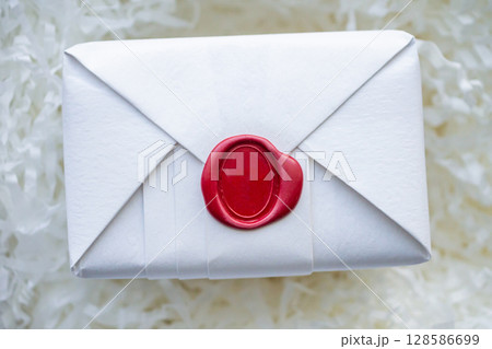 Wax seal stamp on white paper wrap packaging parcel box 128586699
