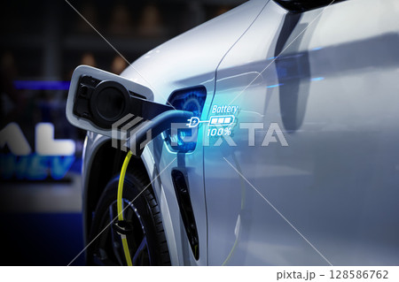 Power cable pump plug in charging power to electric vehicle EV car. Power cable pump plug in charging power to electric vehicle EV car. 128586762