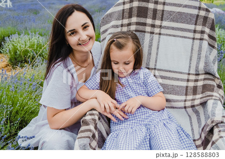 The delicate purple shade of the girl's dress echoes the color of lavender The delicate purple shade of the girl's dress echoes the color of lavender 128588803