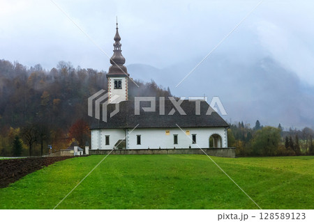 Countryside landscape and church before rain Countryside landscape and church before rain 128589123