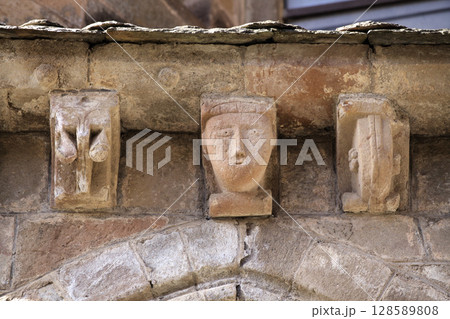 Unique medieval sculptures on the facade of Abbey Church of Sainte-Foy in Conques, France Unique medieval sculptures on the facade of Abbey Church of Sainte-Foy in Conques, France 128589808
