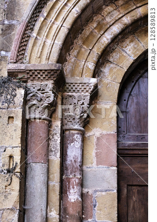 Columns of Abbey Church of Sainte-Foy in Conques, France, intricate stone carvings 128589813