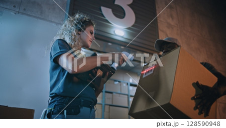 Diverse Employees Carrying Cardboard Boxes. Female Manager Scanning Parcels, Using Digital Tablet 128590948