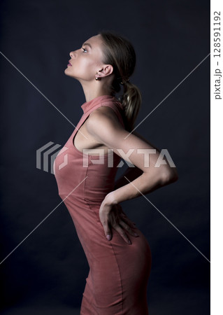 portrait of a young beautiful woman on a dark background portrait of a young beautiful woman on a dark background 128591192