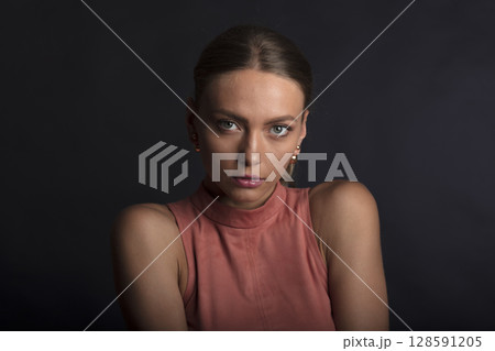 portrait of a young beautiful woman on a dark background portrait of a young beautiful woman on a dark background 128591205
