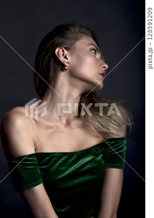 portrait of a young beautiful woman on a dark background portrait of a young beautiful woman on a dark background 128591209
