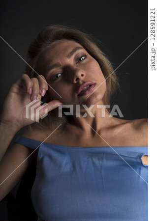 portrait of a young beautiful woman on a dark background portrait of a young beautiful woman on a dark background 128591221