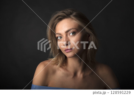 portrait of a young beautiful woman on a dark background portrait of a young beautiful woman on a dark background 128591229
