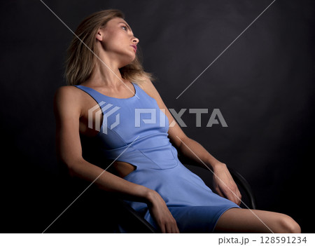 portrait of a young beautiful woman on a dark background 128591234