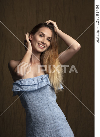 portrait of a young attractive woman on a dark background 128591404