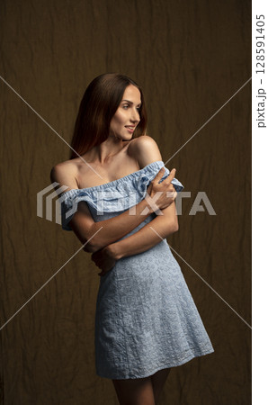 portrait of a young attractive woman on a dark background portrait of a young attractive woman on a dark background 128591405