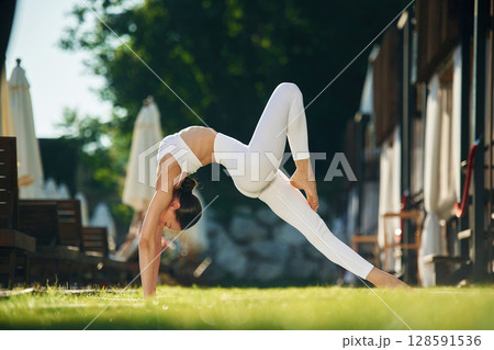 Long legs. Young woman in yoga clothes is outdoors 128591536