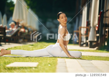Fitness day. Young woman in yoga clothes is outdoors Fitness day. Young woman in yoga clothes is outdoors 128591549