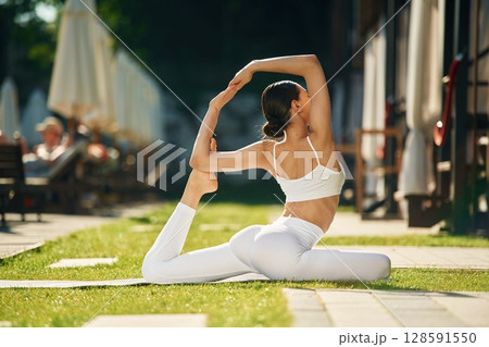 Fitness day. Young woman in yoga clothes is outdoors Fitness day. Young woman in yoga clothes is outdoors 128591550