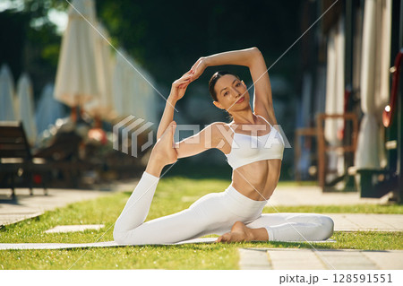 Fitness day. Young woman in yoga clothes is outdoors 128591551