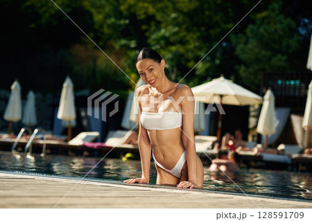 Enjoying the pool. Woman in white underwear Enjoying the pool. Woman in white underwear 128591709