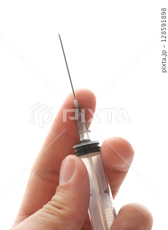 Syringe in hand 128591898
