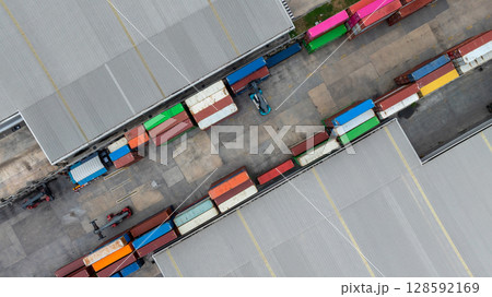 Aerial view semi truck cargo trailer at logistic park warehouse goods, Distribution warehouse shipping supply chain, Business transportation logistic freight shipping cargo by semi truck cargo Aerial view semi truck cargo trailer at logistic park warehouse goods, Distribution warehouse shipping supply chain, Business transportation logistic freight shipping cargo by semi truck cargo 128592169
